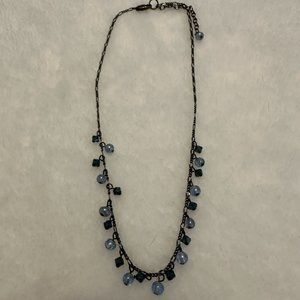 Costume gunmetal tone necklace with blue beads.